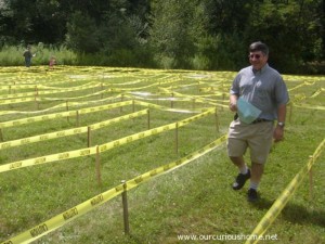 David C walking through the maze, map in hand, with a smile on his face.