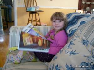 K reading a magazine on Grandma's couch