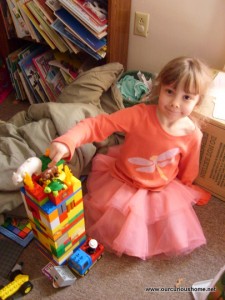 K pointing at the duplo animals at the top of her tower