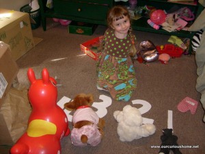 K showing her stuffed animals the numbers