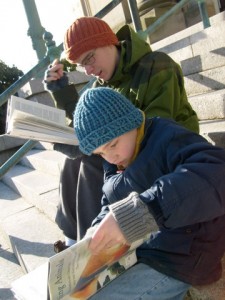 M and Ben reading on the library steps