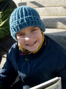 M smiling while wearing the Library Window Watchcap small size