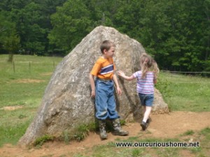 M and K playing on a rock at Sturbridge Village