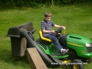 B driving Daddad's lawn tractor