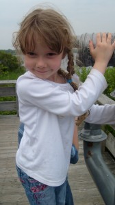 K dancing on the platform overlooking the salt pond while Grandma tries to watch birds through her binoculars