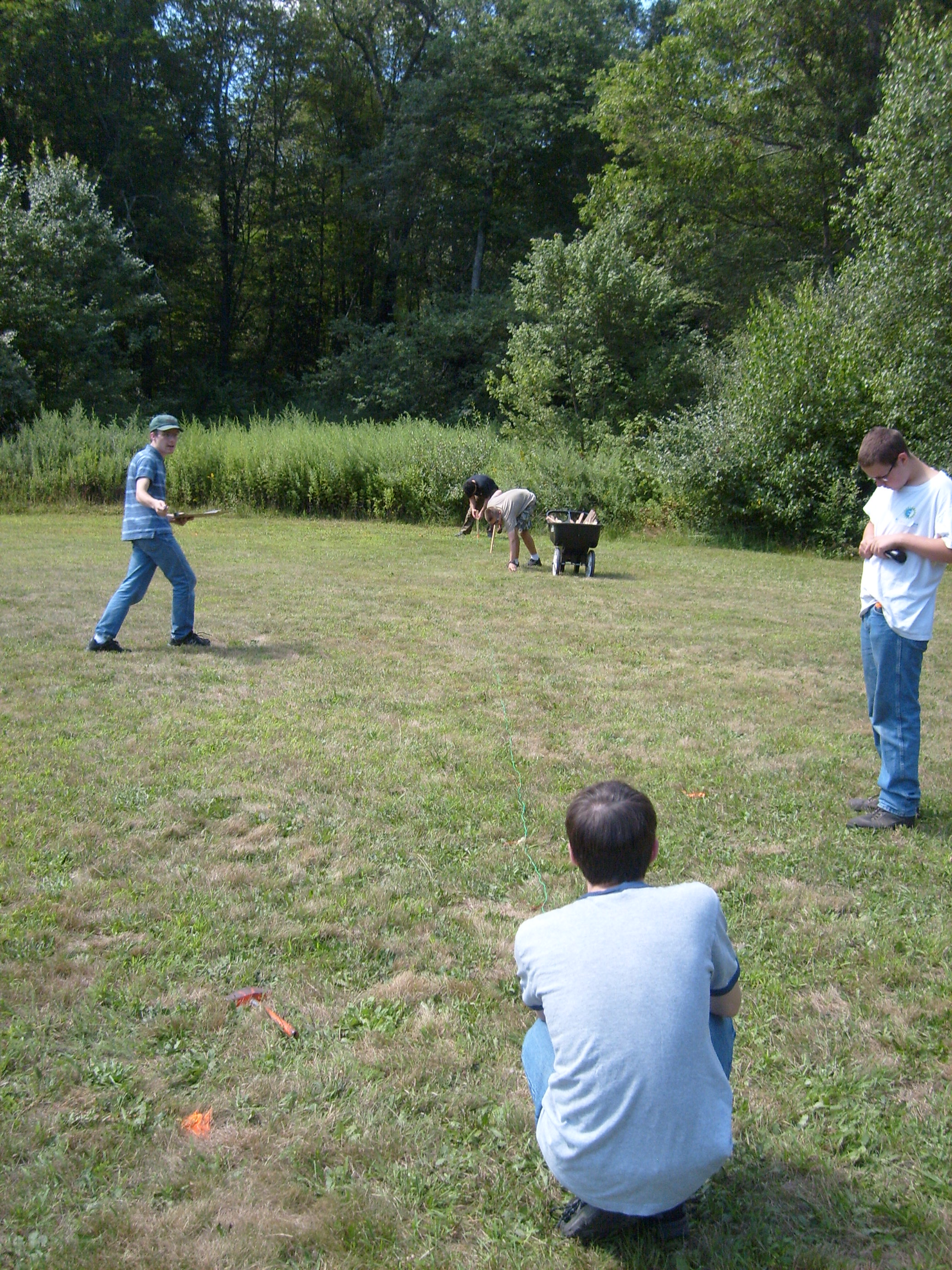 Volunteers stretch out the 60' wire to place the maze corner post.