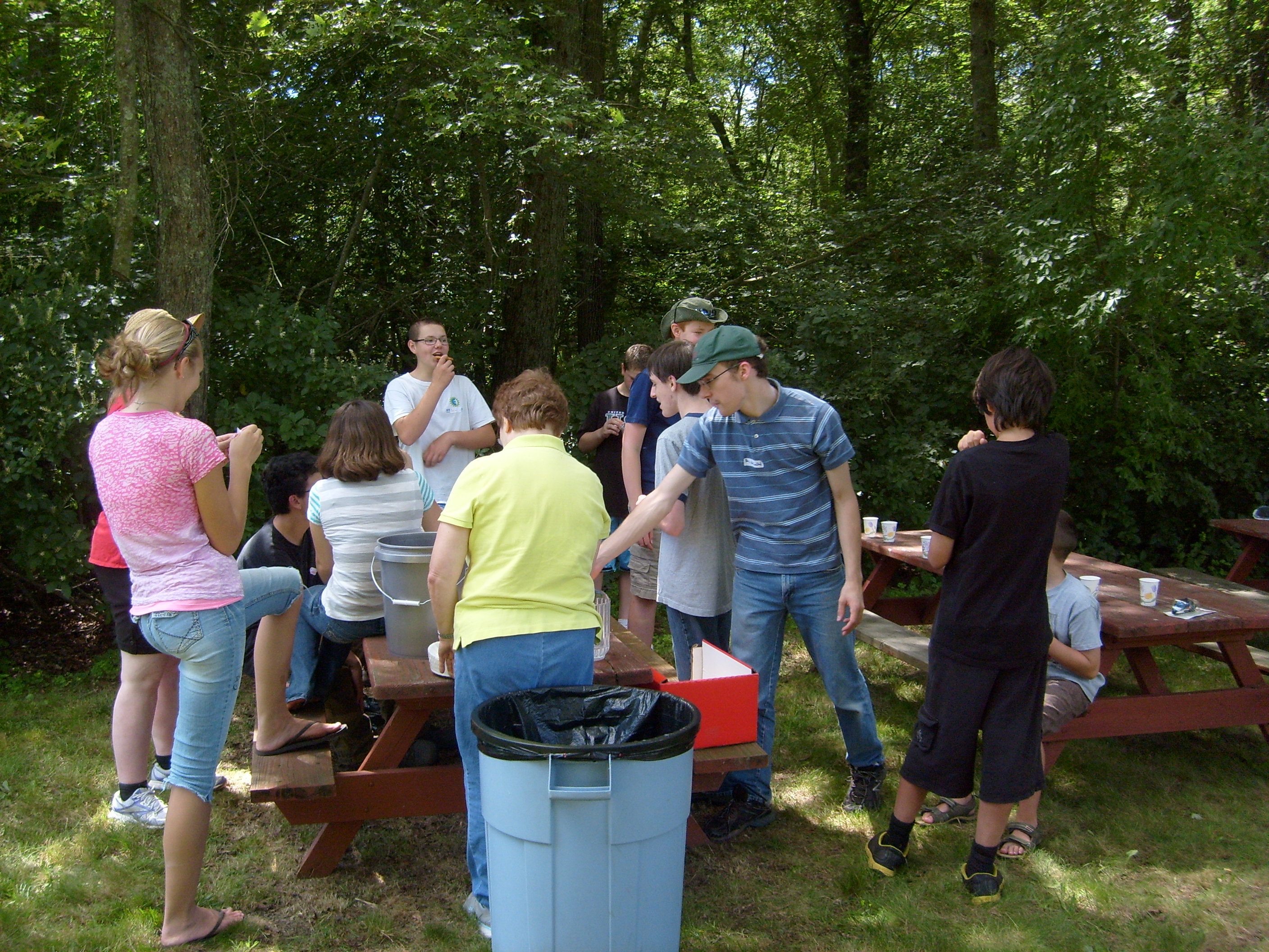 The teenage volunteers enjoy barbecue lunch