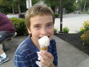 M grinning behind an ice cream cone