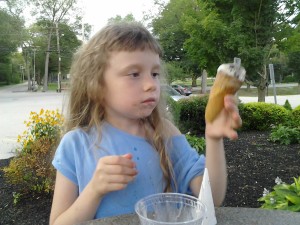 K examining her bitten ice cream cone