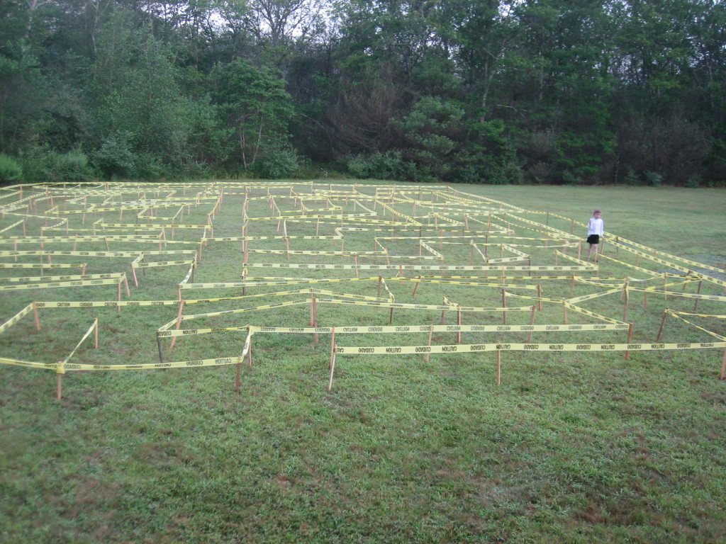 K. wanders through the caution tape maze, early in the morning