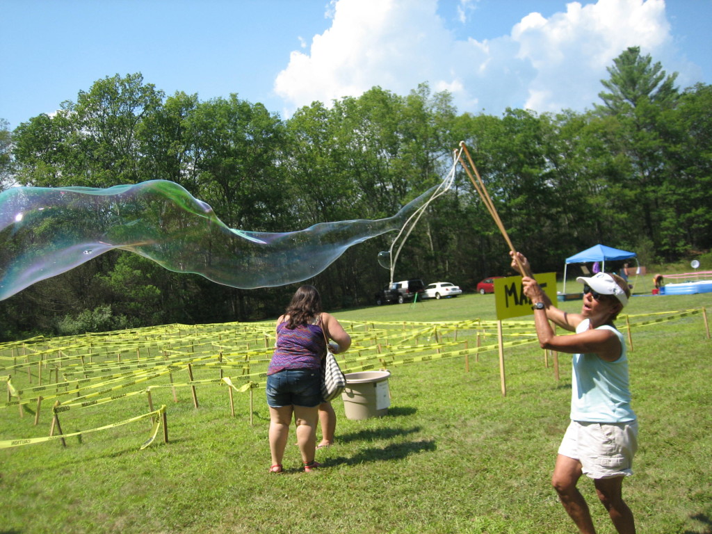 Linda makes giant bubbles near the maze.