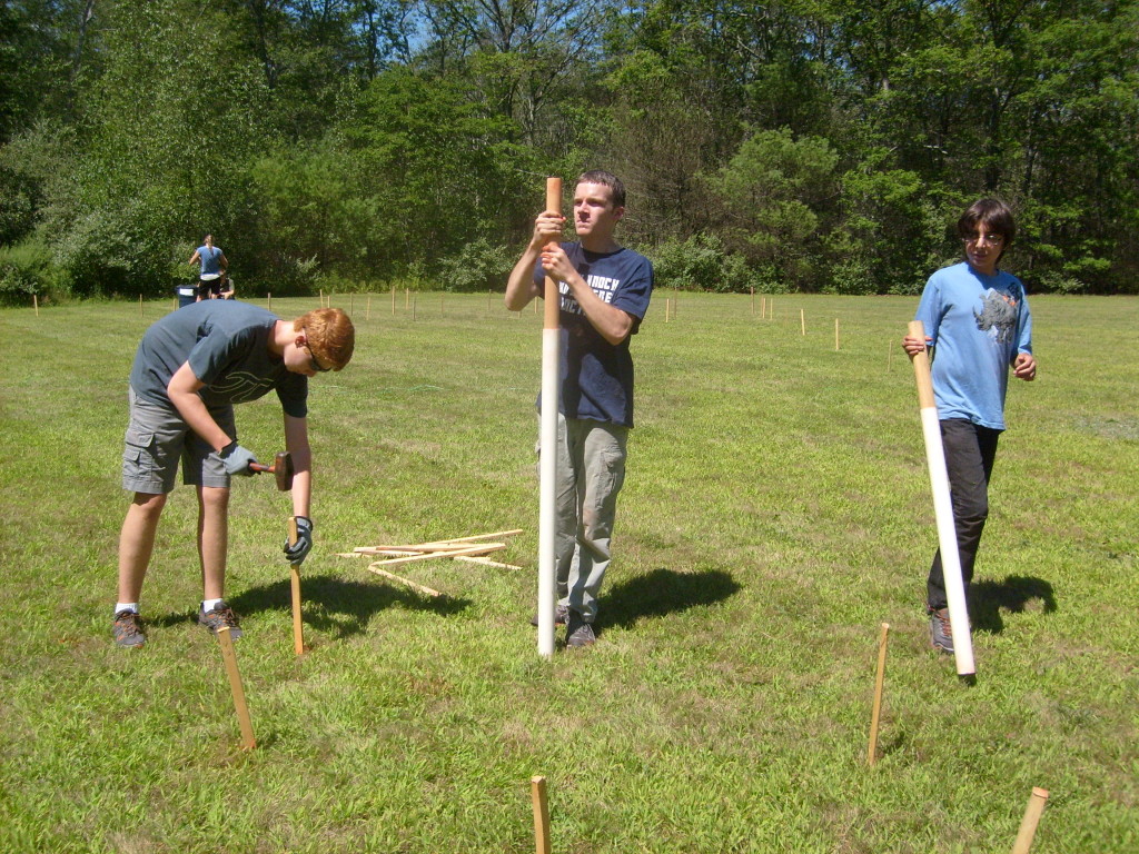 Benjamin, T., and N. working together. Notice the experimental "stake pounders" made from PVC and dowels.