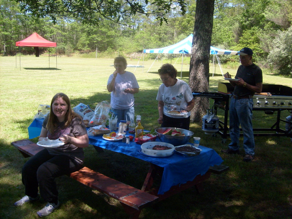 J. grinning at "Uncle Dan". Carol, Cindy, and Gene in the background.