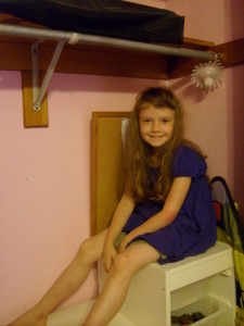 K sitting in her closet