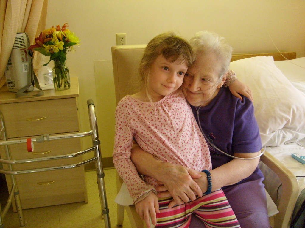 K sitting on our friend's lap in the Life Care Center