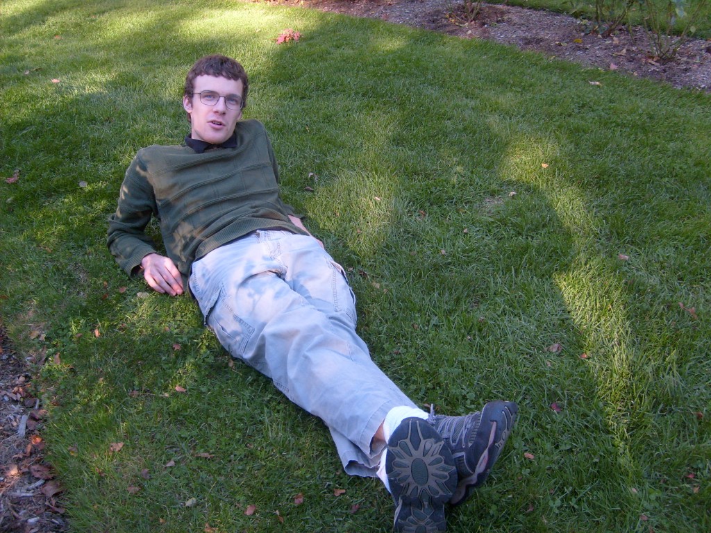 Ben reclining on the grass at Capron Park