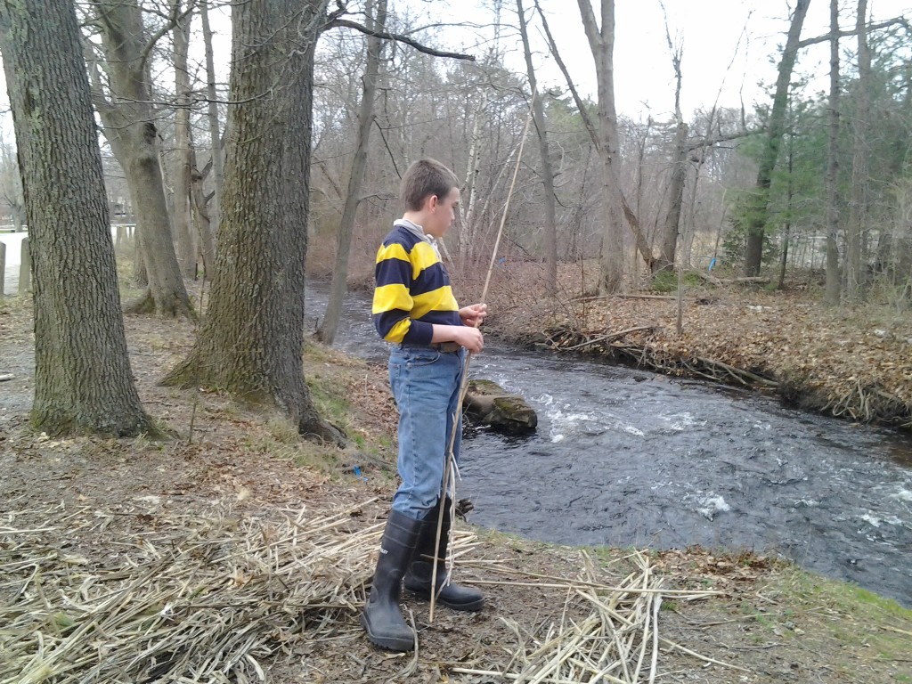 M looks at the Ten Mile River, which is moving rather rapidly.