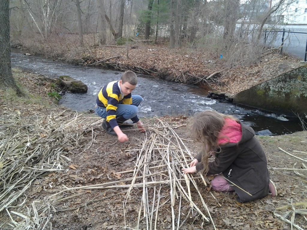 M and K keep working on the raft.