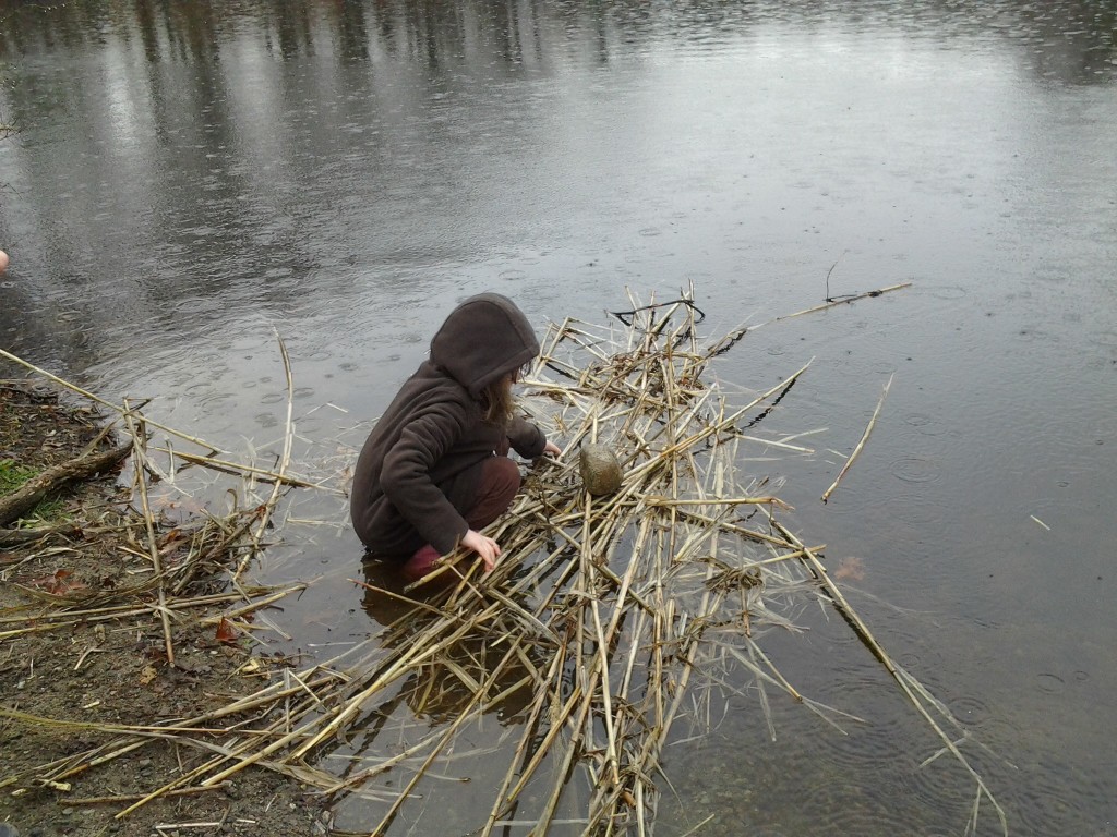 K launches the raft with a rock as cargo.