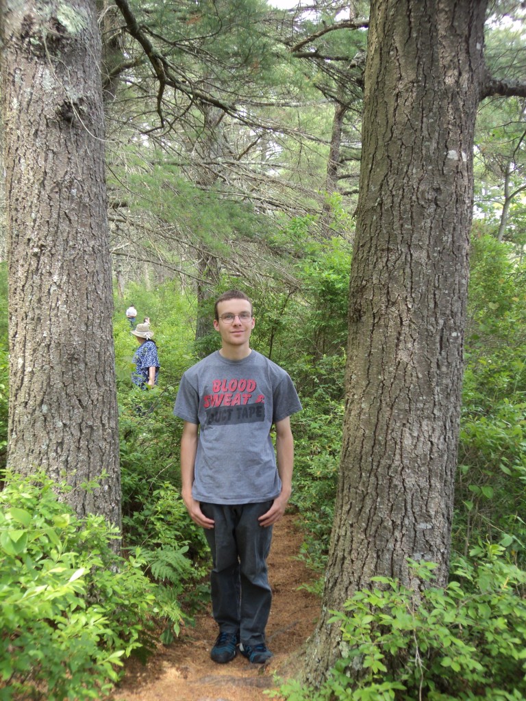 B between the trees wearing his blood sweat and duct tape tee shirt