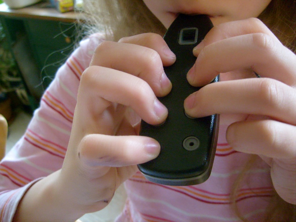 K playing Ocarina - I hoped she'd understand what I meant by cover the holes fully and completely if she saw a photo but then her form got better - maybe I had standardized testing on the brain.