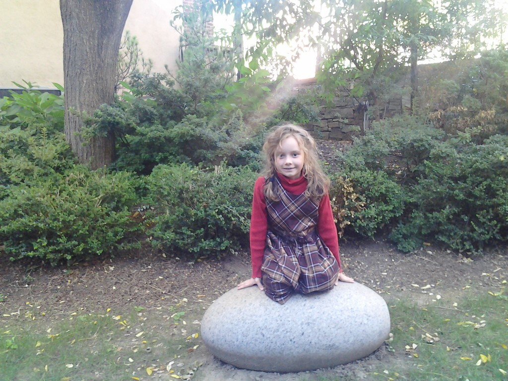 K sitting on what turned out to be a sculpture of Mirth