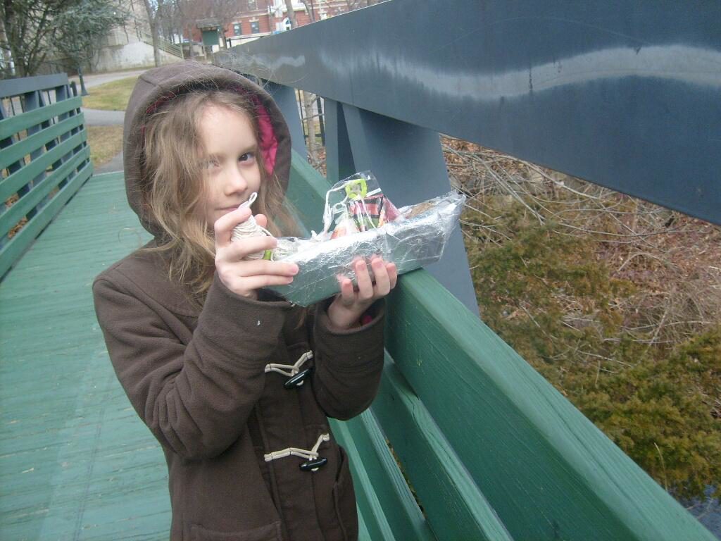 K and her tinfoil and packing tape wrapped paper boat