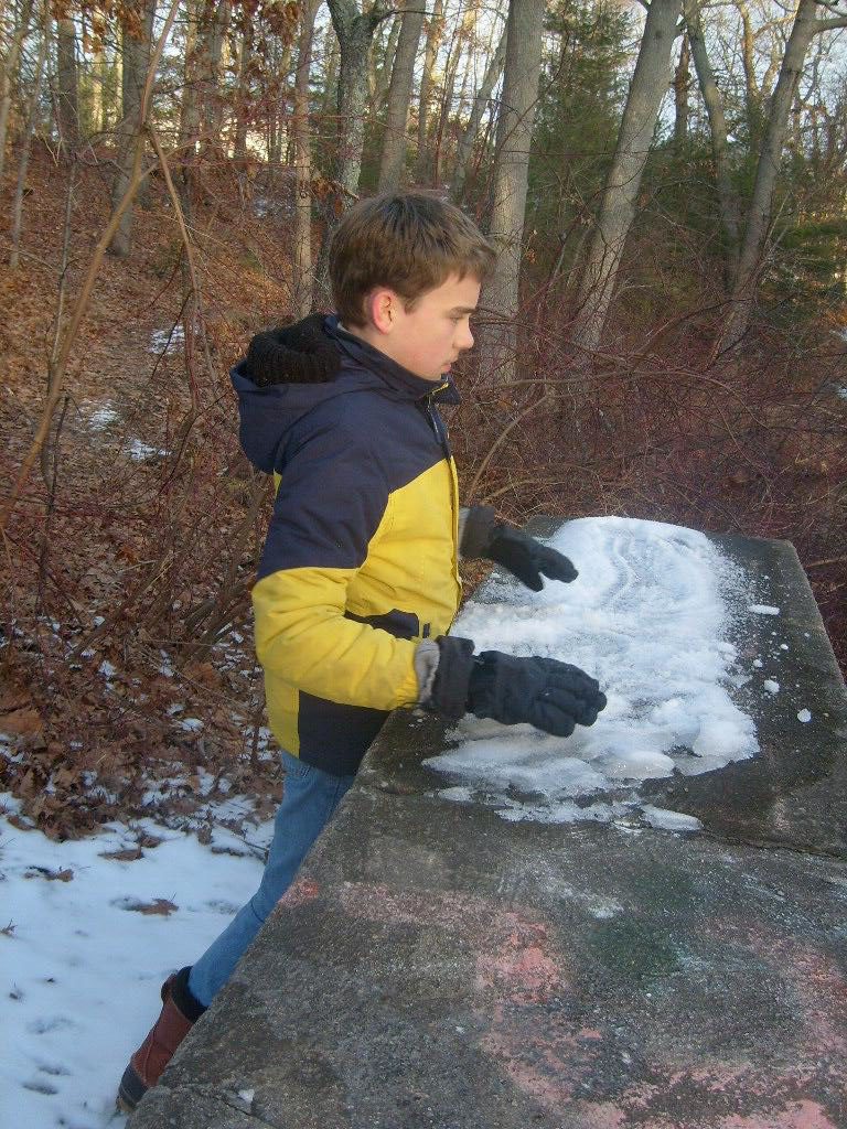 M watching his snowballs bounce off the waterfall