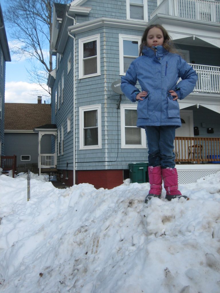 arms akimbo on top of a really high snowdrift