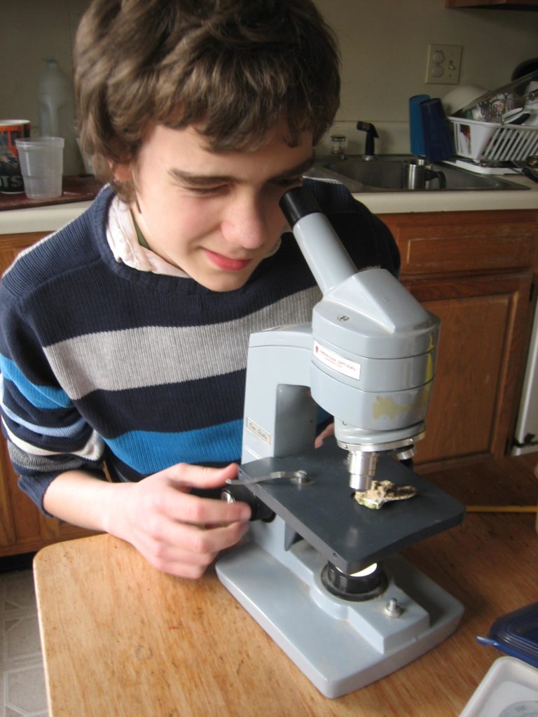 M squinting into the microscope