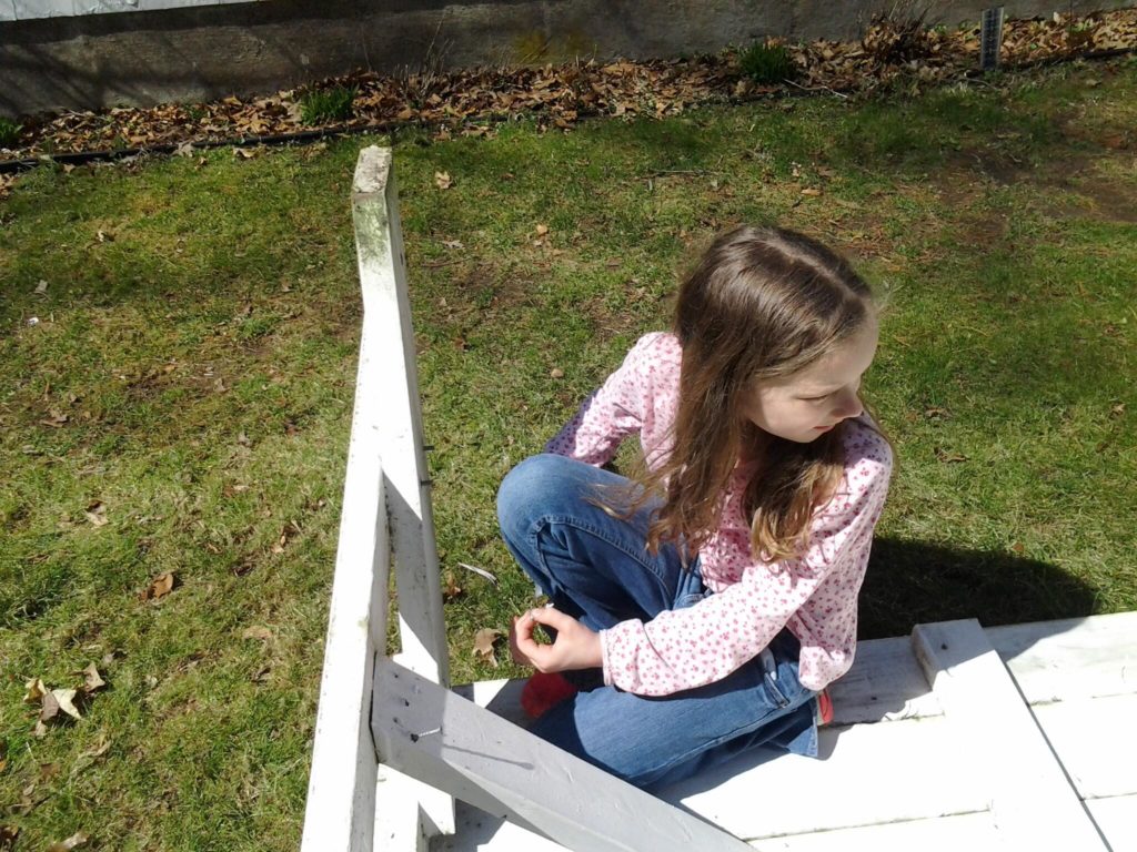 K taking the bolts out of Grandma's old picnic table.