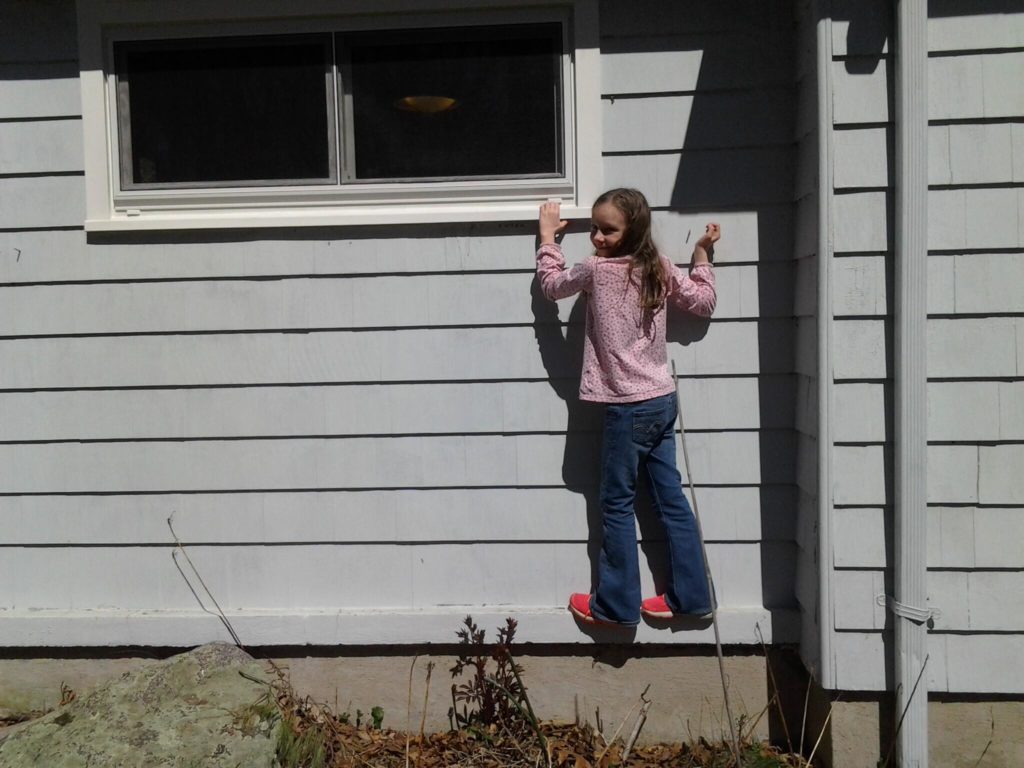 K climbing the wall at Grandma's house