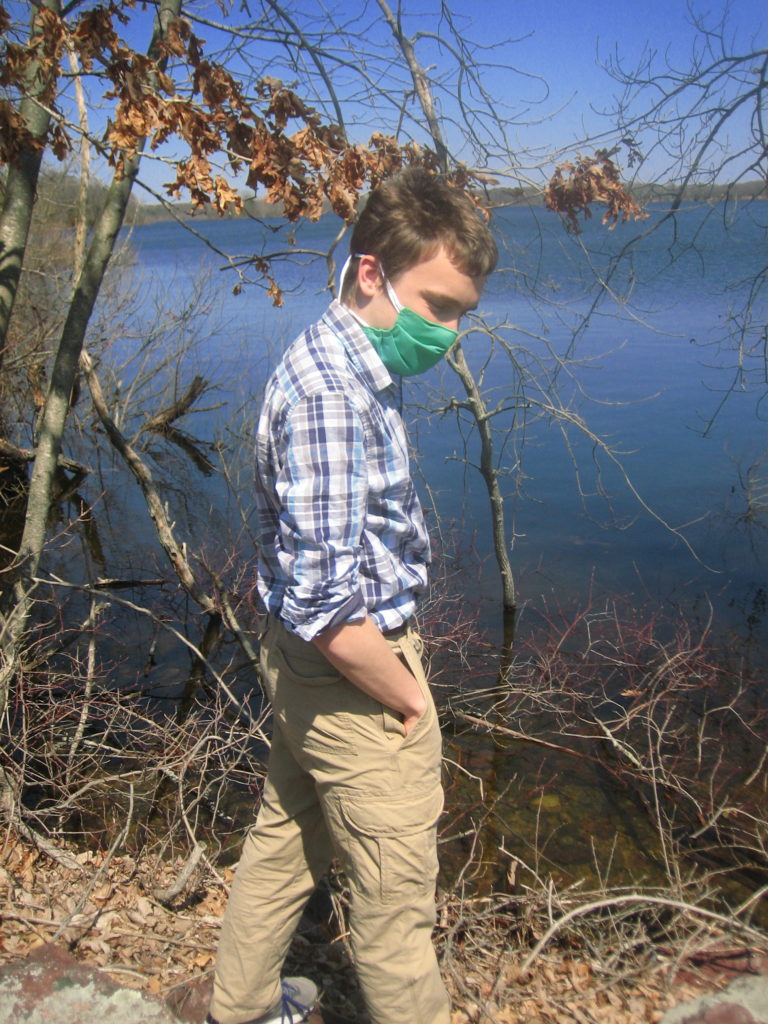 Matt wearing a green facemask standing by reservoir