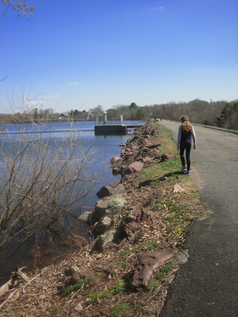K walking along reservoir top