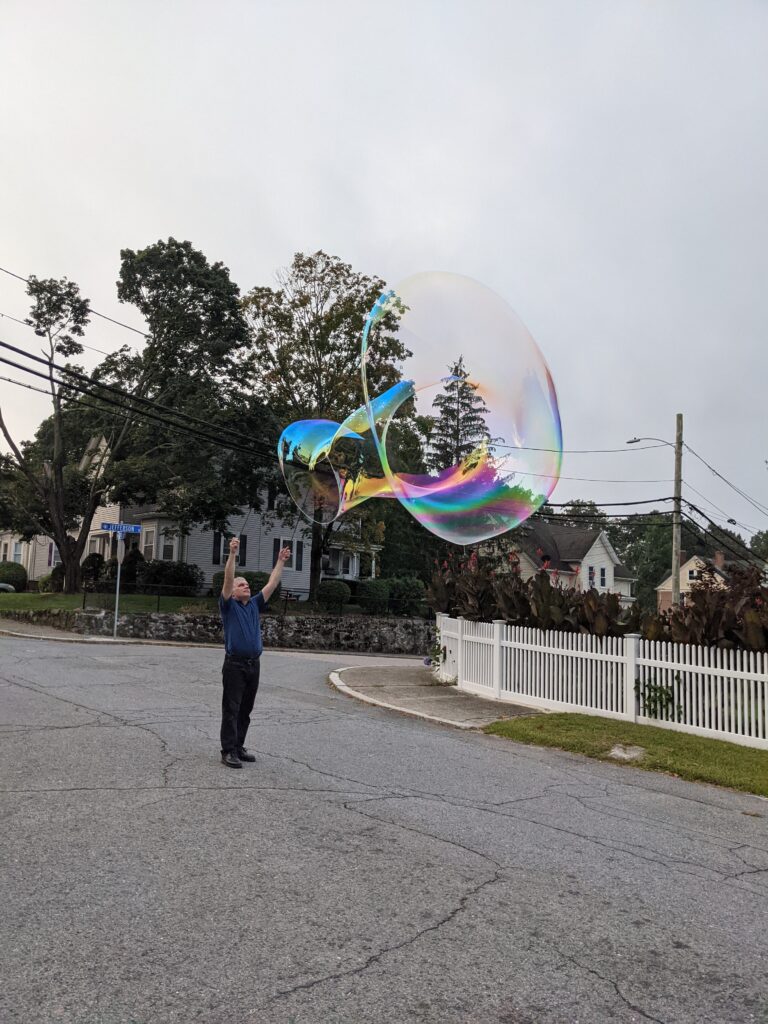 Blowing a giant soap bubble