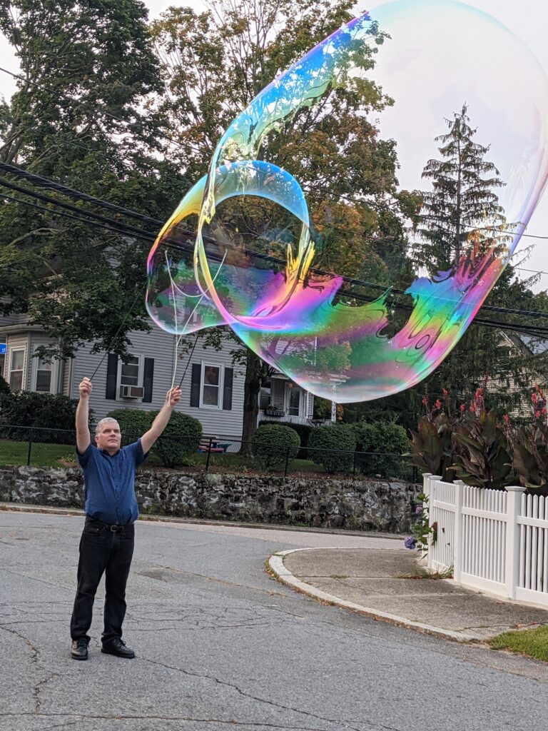 Blowing a giant soap bubble